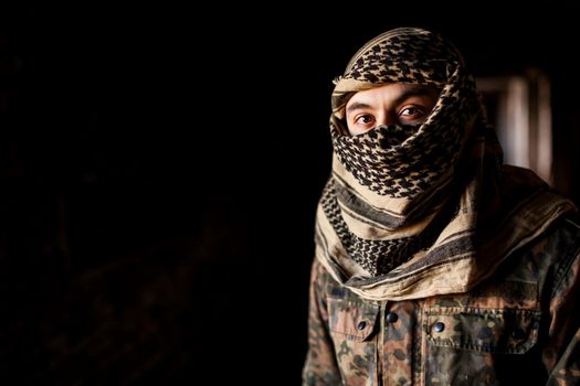 Portrait of serious middle eastern man with AK-47