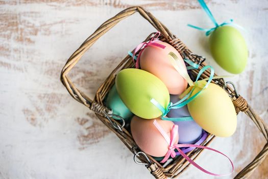 Box full of colorful eggs on rustic background