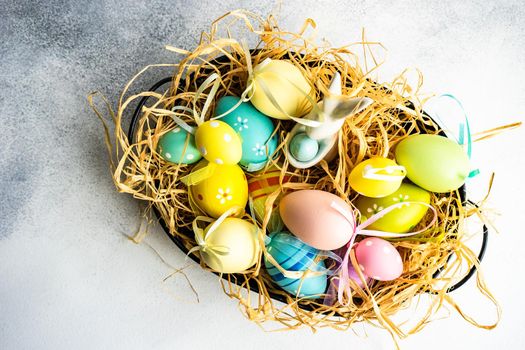 Box full of colorful eggs on rustic background