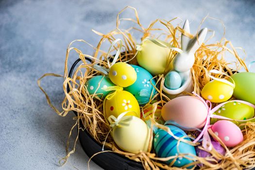 Box full of colorful eggs on rustic background