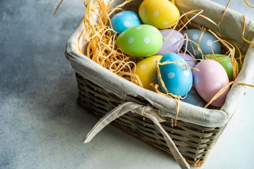 Box full of colorful eggs on rustic background