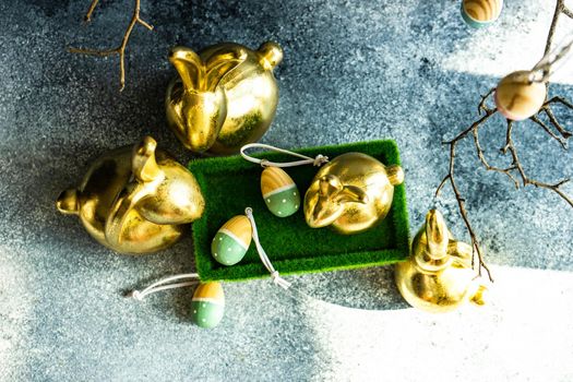 Place setting for festive Easter dinner using with golden bunnies