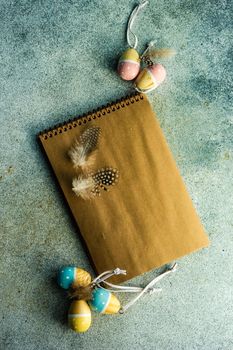 Easter card concept with craft paper notepad on concrete table