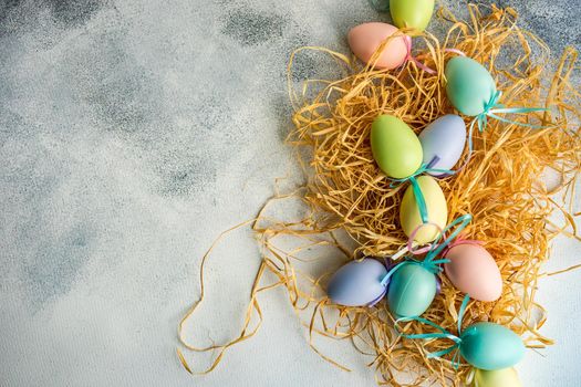 Box full of colorful eggs on rustic background