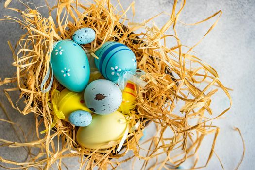 Box full of colorful eggs on rustic background