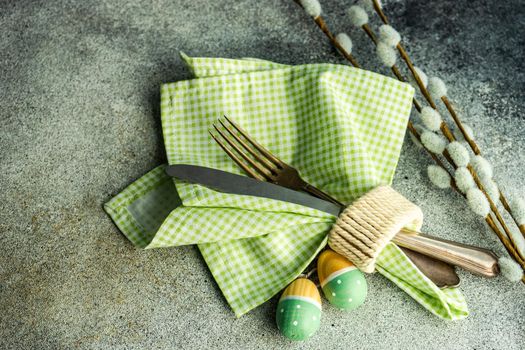 Table setting for festive Easter dinner served on concrete background