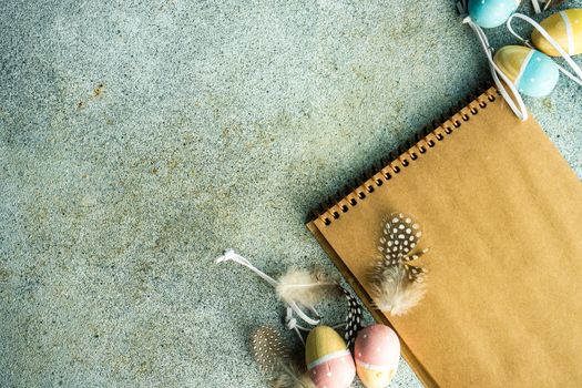 Easter card concept with craft paper notepad on concrete table