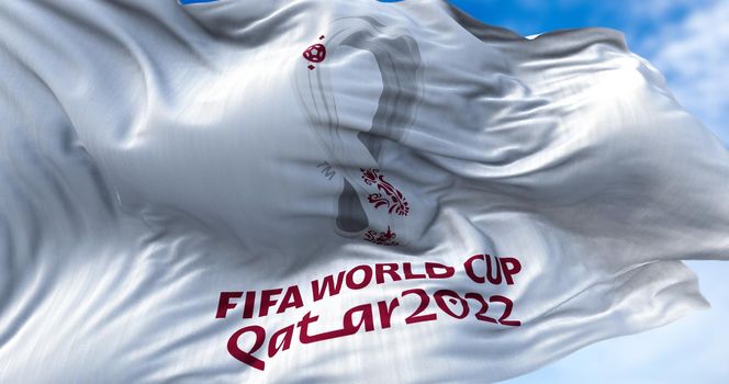 Doha, Qatar, October 2021: Flag with the 2022 Fifa World Cup logo flapping in the wind. The event is scheduled in Qatar from 21 November to 18 December 2022