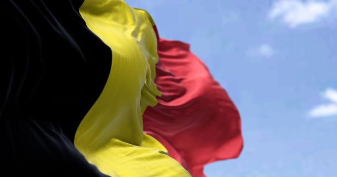 Detail of the national flag of Belgium waving in the wind on a clear day. Democracy and politics. Patriotism. Selective focus.