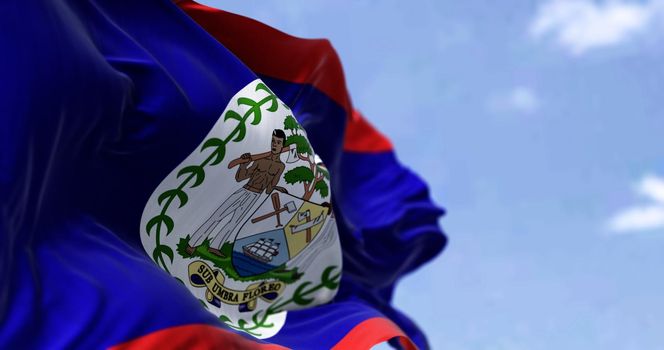 Detail of the national flag of Belize waving in the wind on a clear day. Democracy and politics. Patriotism. Central american country. Selective focus.