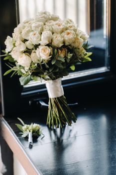 Wedding bouquet of roses lying on the surface. Wedding floristry.