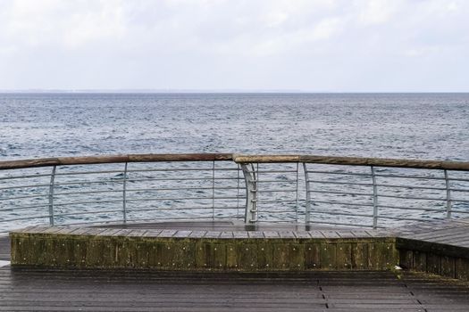 Niendorf, Germany - 30.January 2022: View of the stormy Baltic Sea at a pier in Niendorf on Timmendorfer Strand