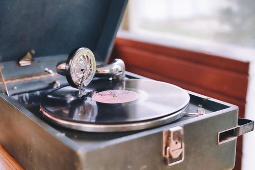 The gramophone record is played on the old potiphon. Old turntable