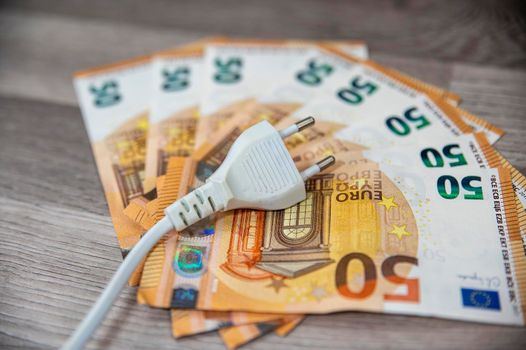50 euro bills with power outlet indicating high consumption