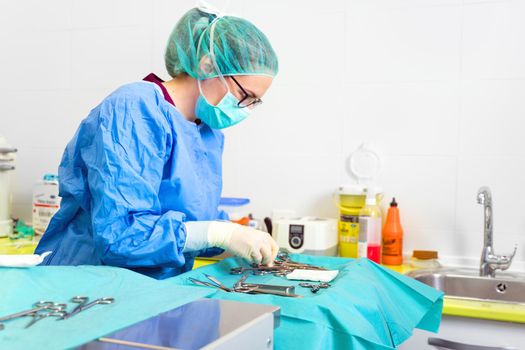 Female nurse preparing operation theatre for surgery. High quality photo