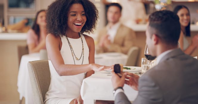 4k video footage of a man proposing to his girlfriend while on a date at a restaurant