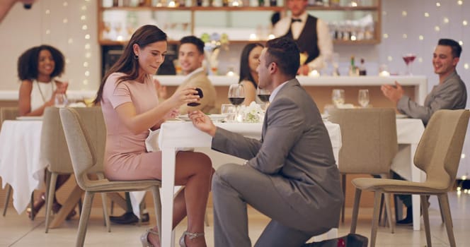 4k video footage of a man proposing to his girlfriend while on a date at a restaurant