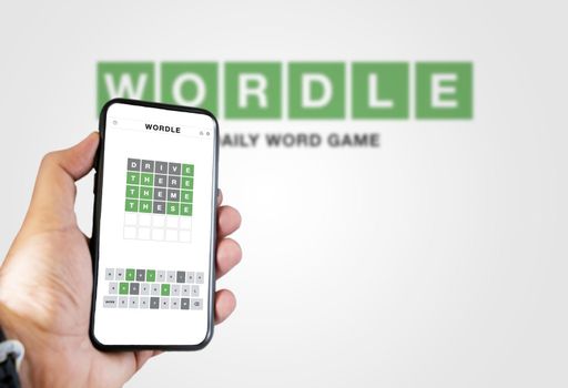 Rome, Italy, January 2022: hand holding a phone with Wordle game running. Wordle is a web-based word game. The game was purchased by The New York Times Company in January 2022