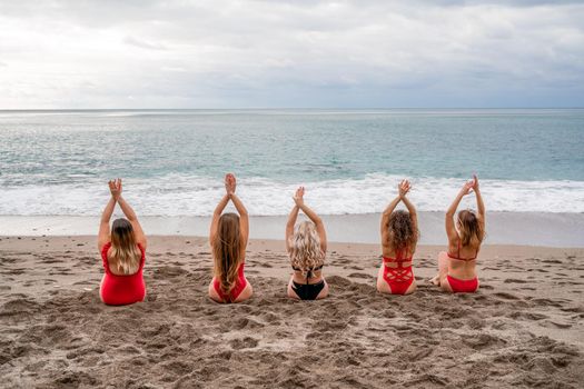 Big happy family or group of five friends is having fun against sunset beach. Beach holidays concept