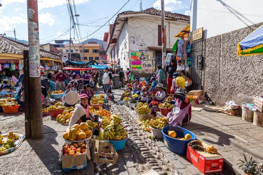 Cusco, Peru - August 08, 2015: People selling and buying fruits at a market in the steets
