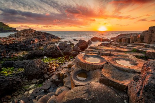 sunset over basalt columns Giant's Causeway known as UNESCO World Heritage Site, County Antrim, Northern Ireland