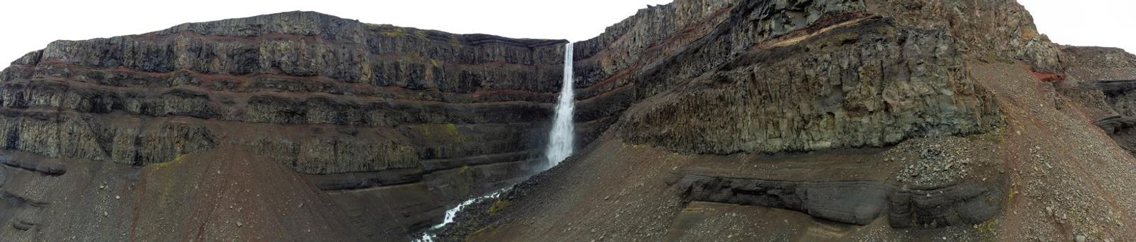 Famous Svartifoss waterfall wide panorama under cloudy sky in Iceland