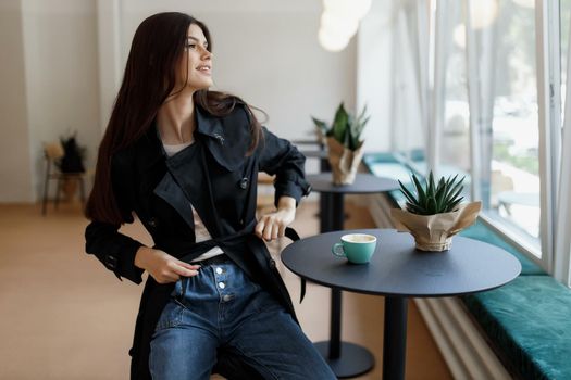 beautiful women in a coffee shop with a cup of coffee.