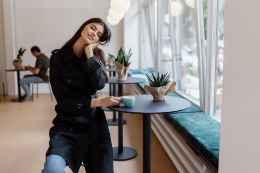 beautiful women in a coffee shop with a cup of coffee.