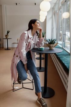 beautiful women in a coffee shop with a cup of coffee.