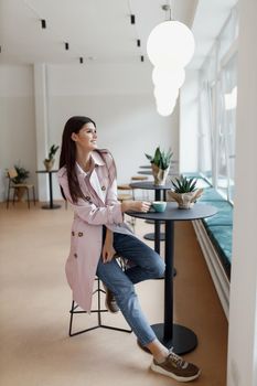 beautiful women in a coffee shop with a cup of coffee.