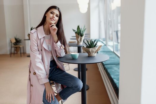 beautiful women in a coffee shop with a cup of coffee.