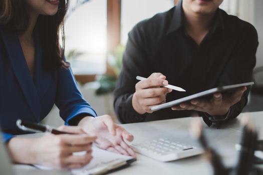 Business people meeting and analyst financial advisor preparing statistical report searching documents on work desk, browsing information online by digital tablet. Accountant Consult concept