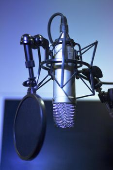 Professional microphone suspended in the air of professional studio