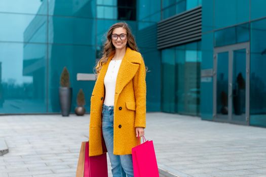 Business Woman With Shopping Bags Dressed Yellow Coat Walking Outdoors Corporative Building Background Caucasian Female Business Person Near Office Building Stylish Businesswoman Season Sale