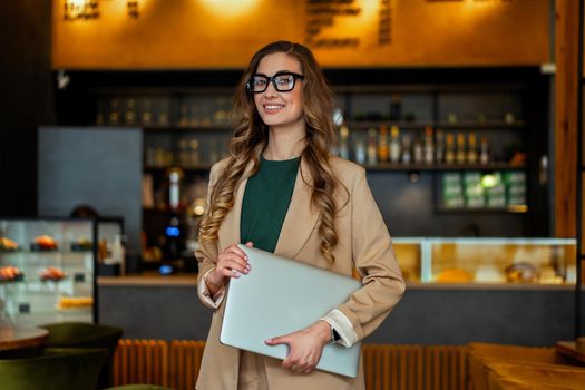 Business Woman Restaurant Owner With Laptop In Hands Dressed Elegant Pantsuit Standing In Restaurant With Bar Counter Background Caucasian Female Glasses Business Person Indoor