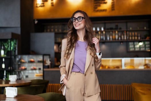 Business Woman Restaurant Owner Dressed Elegant Pantsuit Standing In Restaurant With Bar Counter Background Caucasian Female Glasses Business Person Indoor hands in pockets