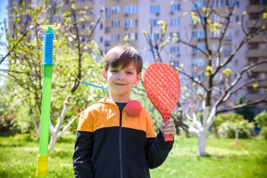 Happy boy is playing tetherball swing ball game in summer camping. Happy leisure healthy active time outdoors concept.