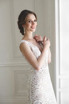 Beautiful bride posing in wedding dress in a white photo Studio.