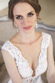 Beautiful bride posing in wedding dress in a white photo Studio.