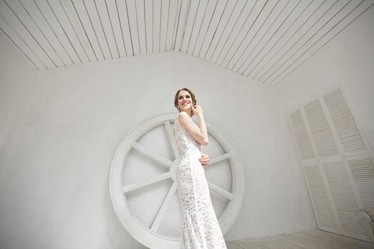 Beautiful bride posing in wedding dress in a white photo Studio.