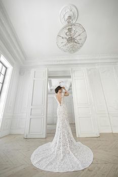 Beautiful bride posing in wedding dress in a white photo Studio.