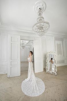 Beautiful bride posing in wedding dress in a white photo Studio.