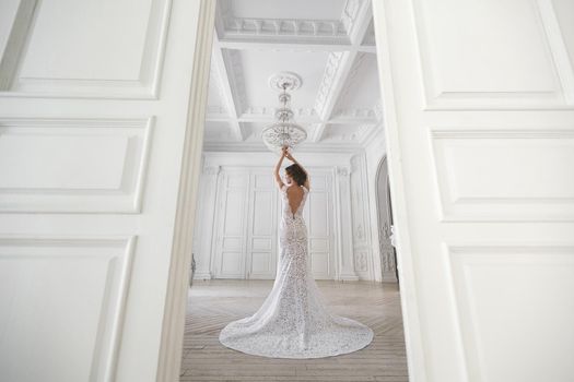 Beautiful bride posing in wedding dress in a white photo Studio.