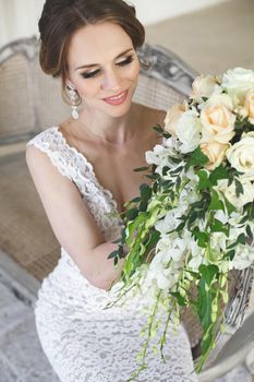 Beautiful bride posing in wedding dress in a white photo Studio.