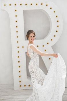 Beautiful bride posing in wedding dress in a white photo Studio.