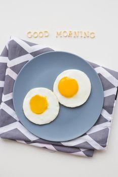 two eggs on a plate, the inscription Good Morning