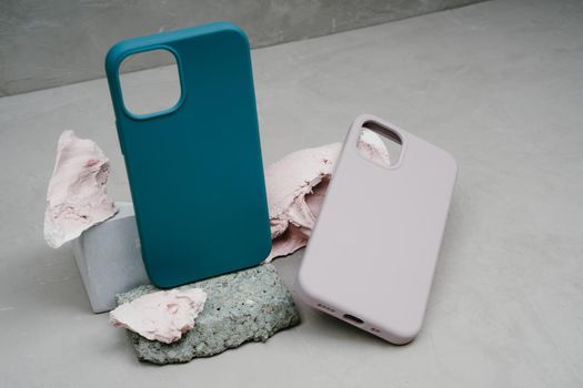 Two silicone cases for smartphone. Cases for smartphone on grey background. Protection for mobile phone. Colorful silicone phone cases.