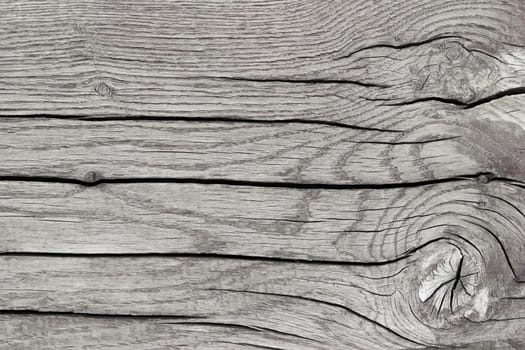 Textured background of gray sawn wood with cracks, horizontal lines, top view, close-up.