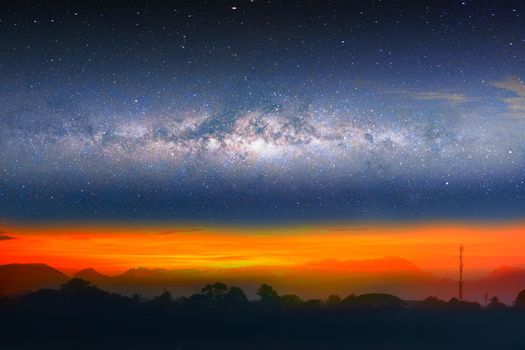 Milky way night landscape sunset light over silhouette mountain, space and stars on sky background