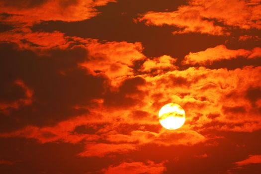 beautiful sunset orange yellow silhouette dark red flame color of sky in back on the cloud
